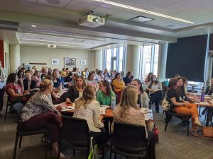 full room of attendees seated in conference room