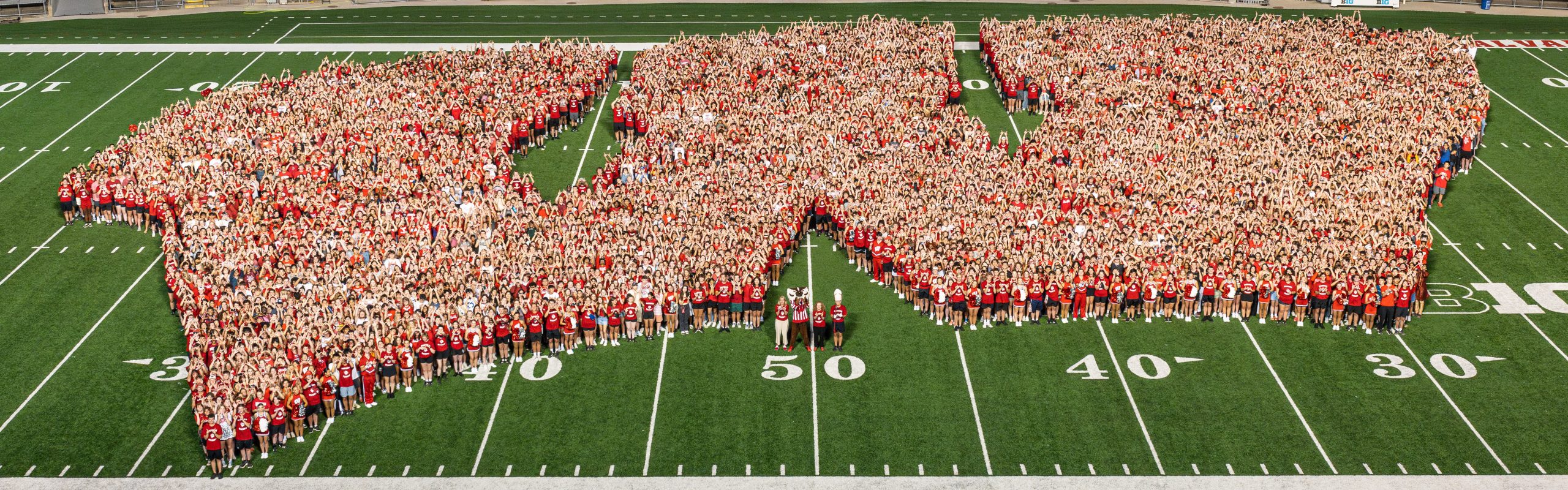 First-year students assemble in the shape of a W on the Camp Randall field