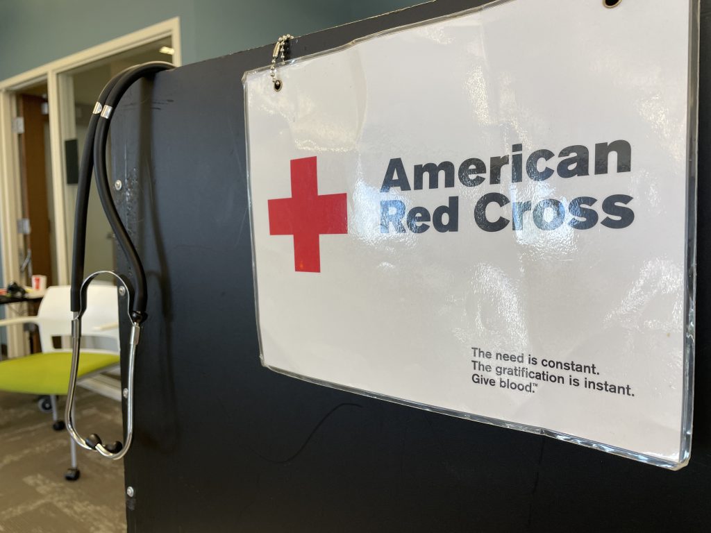 A stethoscope hangs on a portable check-in station