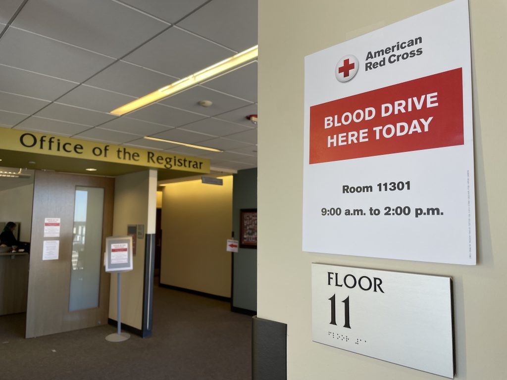 A sign promoting DEM's March 7 blood drive hangs on the wall