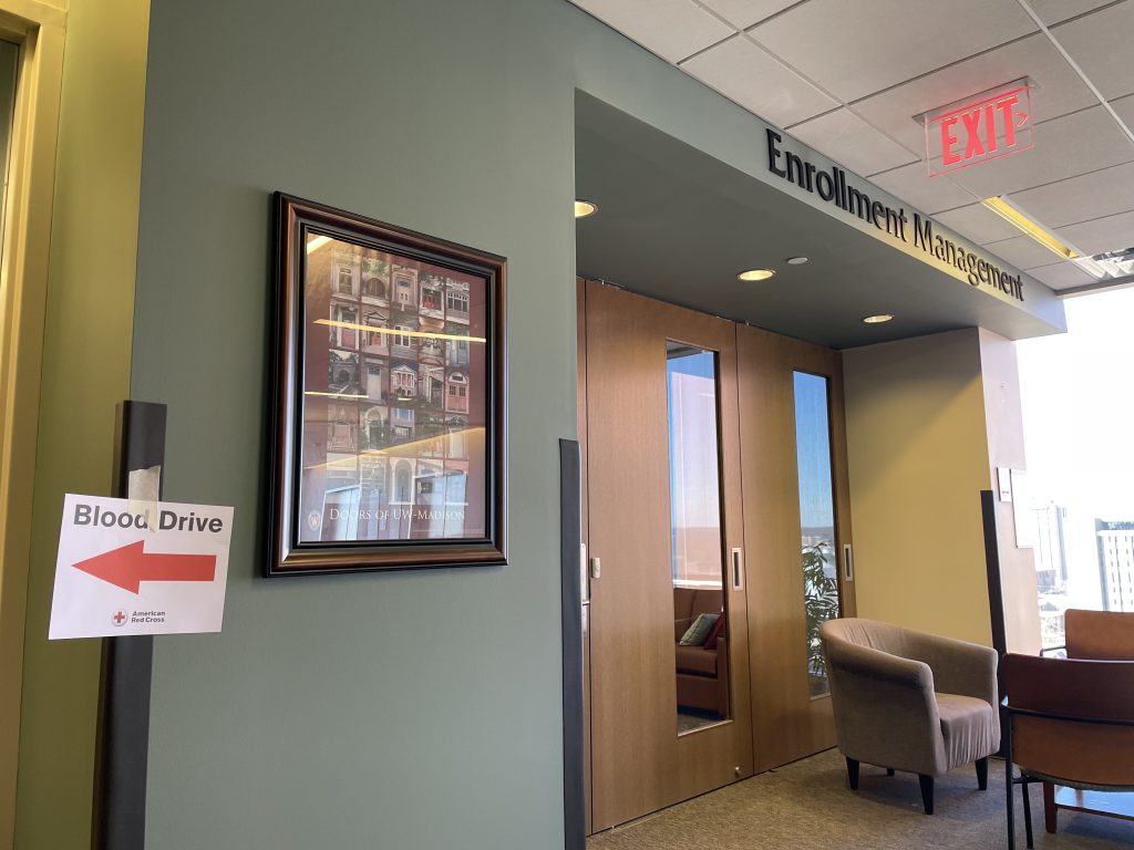 A sign promoting DEM's March 7 blood drive hangs on the wall