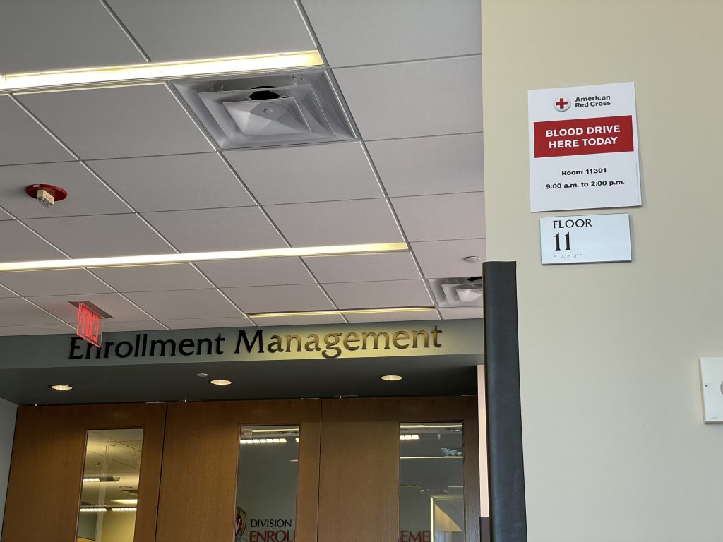 A sign promoting DEM's March 7 blood drive hangs on the wall