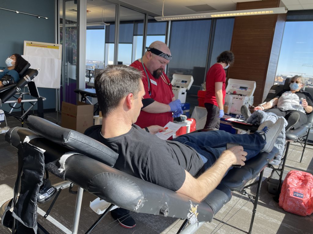 A man sits on a blood donation bed.