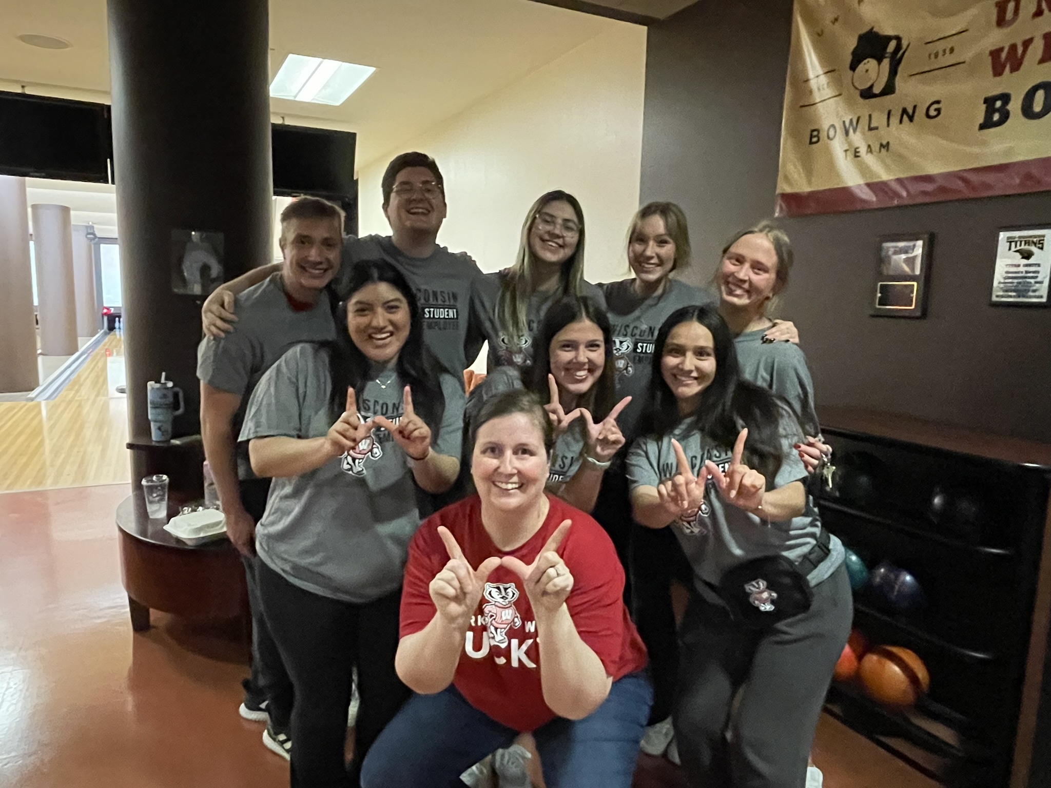 Financial Aid team members forming the letter W with their thumbs and pointer fingers