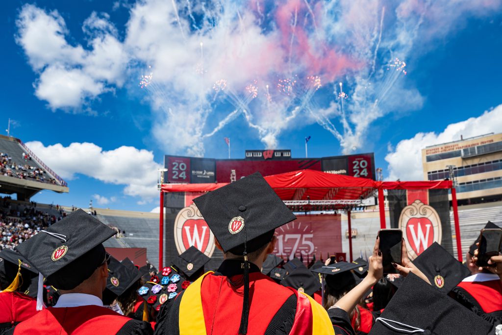 Graduates admire a fireworks display