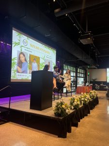 A panel of three Southeast Asian American students still on a stage.