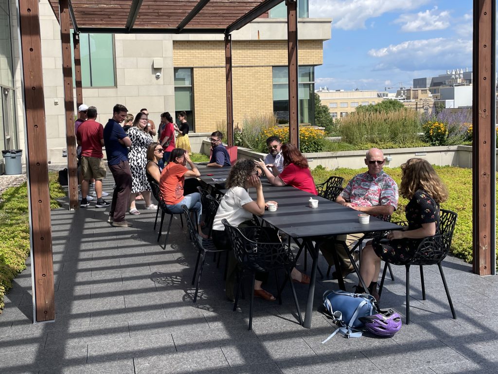 People stand and sit while eating ice cream