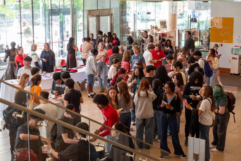 People gathered indoors around tables at a social event.