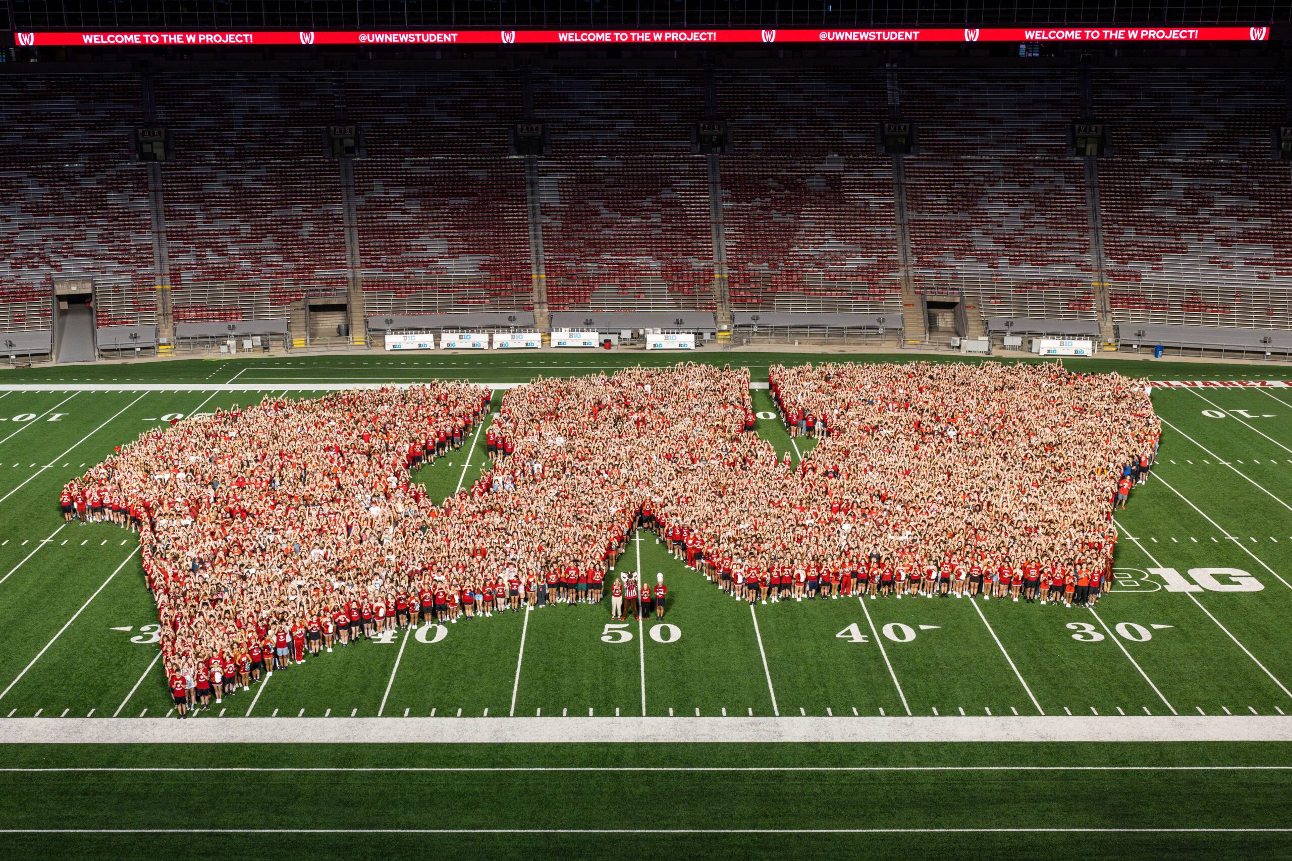 First year students gather on the Camp Randall field in the shape of a "W"