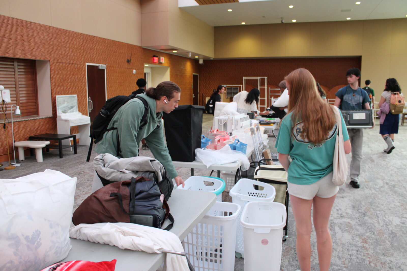 Students stop to look at available laundry baskets