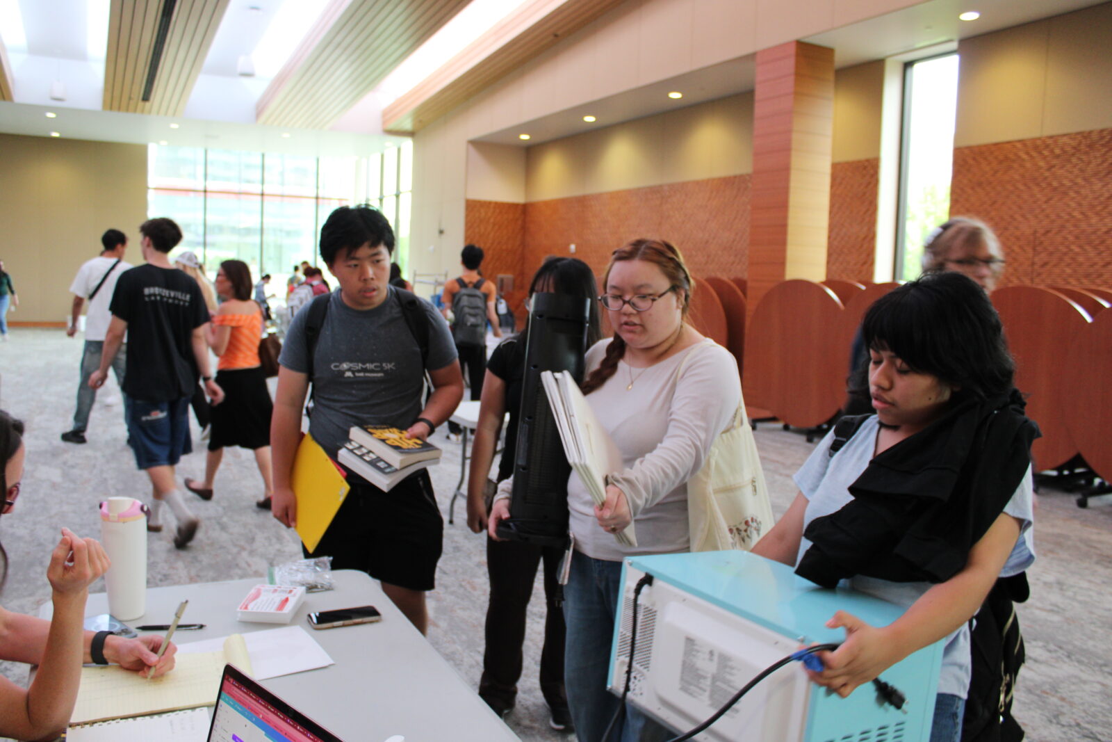 Students line up to check out with their found goods.