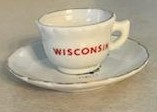 A white cup with "Wisconsin" in red on a white saucer
